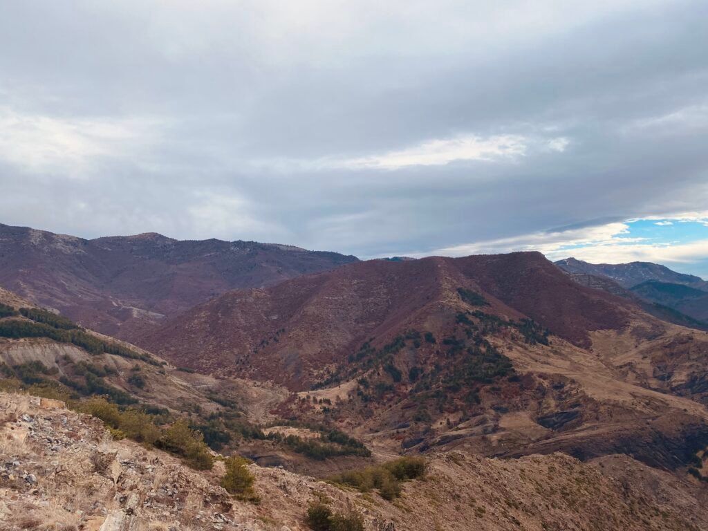 Entorno montañoso con tonos tierra que refleja el origen natural y los valores de moda sostenible y slow fashion de la marca.